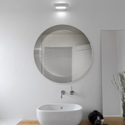 Miroir LED rond à effet 3D pour une touche moderne.