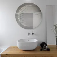 Miroir LED rond à effet 3D pour une touche moderne.